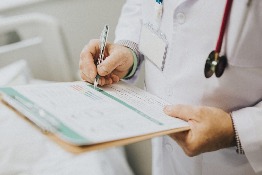 physician noting down symptoms of patient